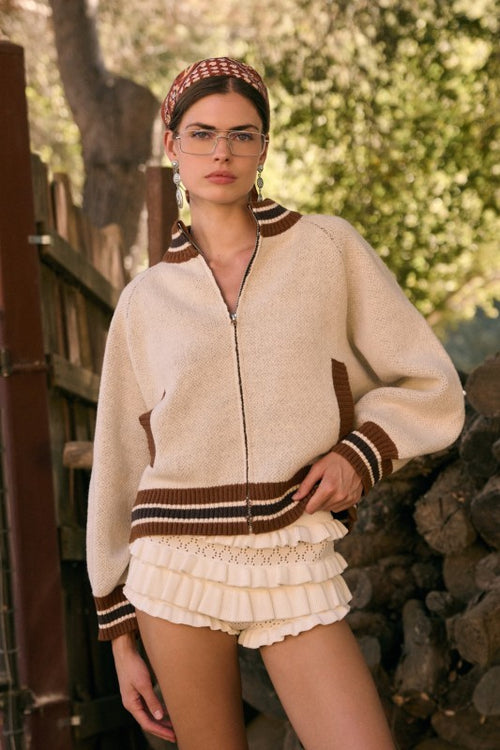 Miss Behavin' Chanel Shorts in ivory with tiered ruffles styled under a cropped cardigan