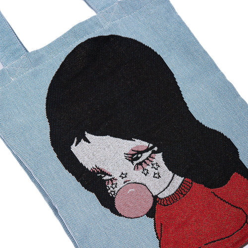 Close-up of tote graphic showing star-tattoo face detail and pink bubblegum bubble
