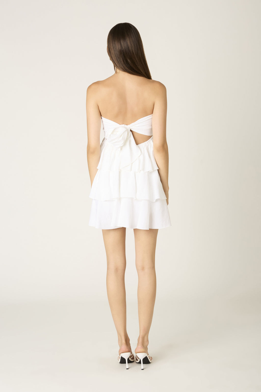 Miss Behavin' Eliana Dress in white showing back cutout with bow tie detail