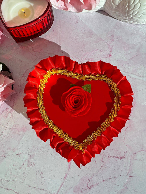 A Shop of Things Chocolate Box Ash Tray in red with heart shaped lid, ruffle trim, and rose
